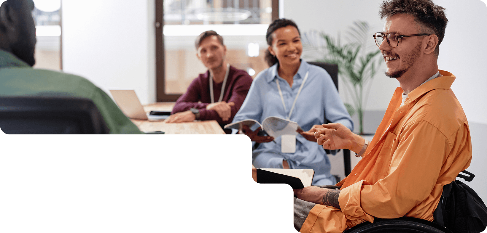 Diverse team meeting with person in wheelchair