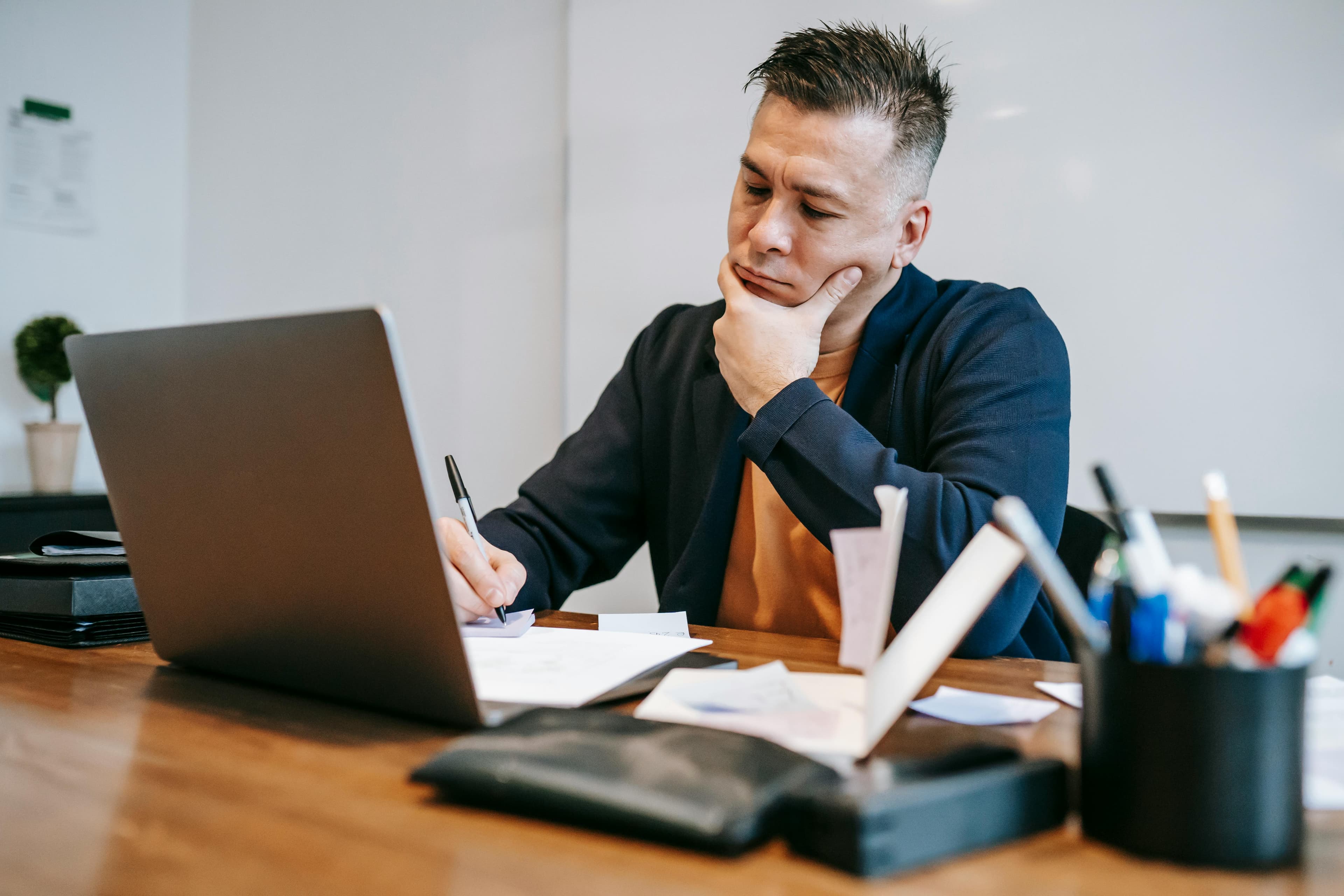 Employer reviewing candidates on a tablet in a modern office.