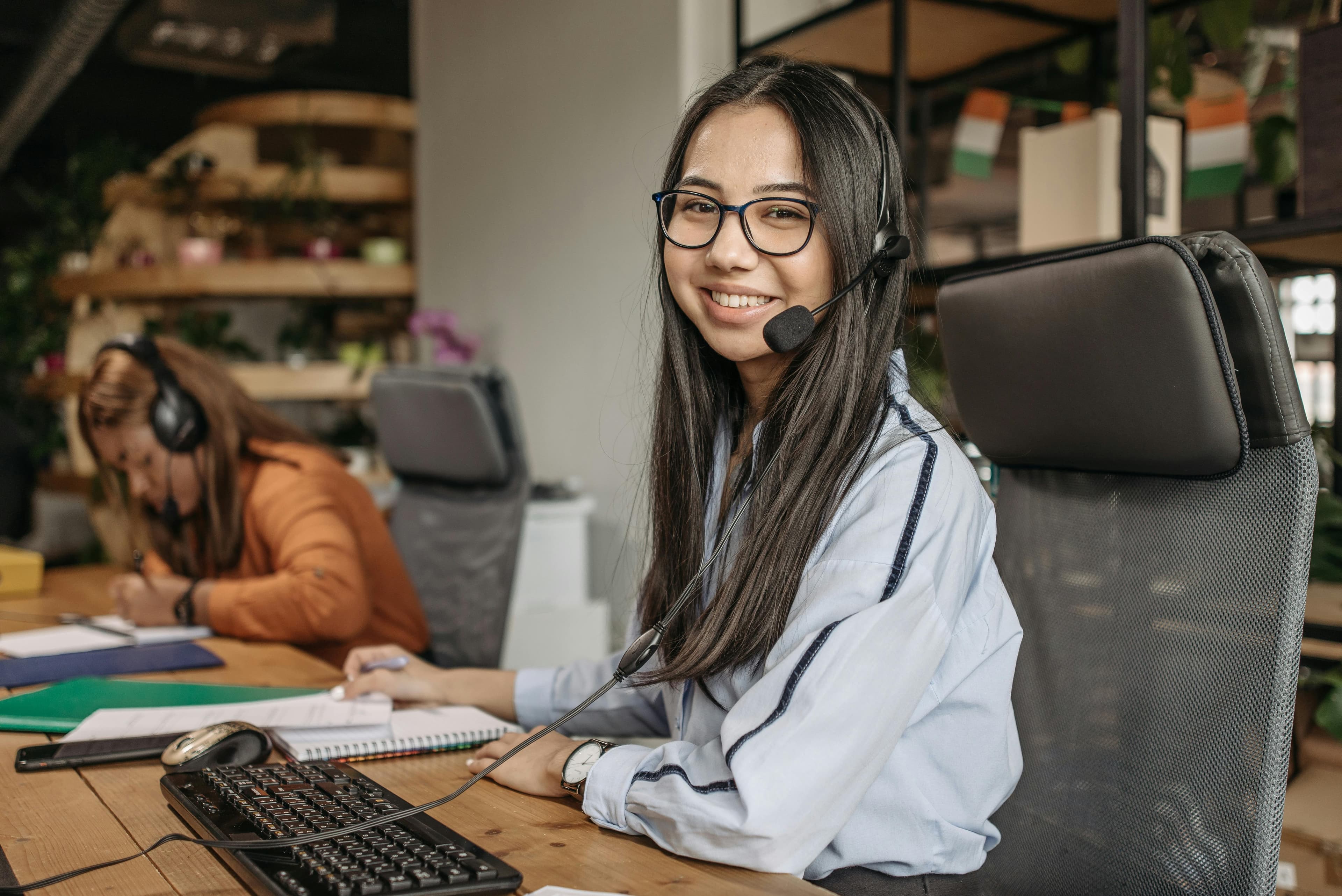Young professional using sign language while working on a laptop.